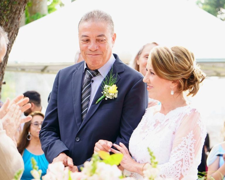 A joyful couple shares a special moment during their outdoor wedding ceremony.