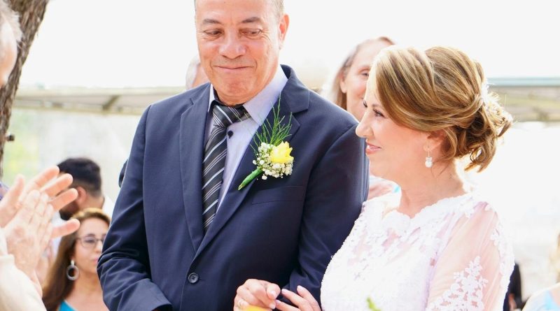 A joyful couple shares a special moment during their outdoor wedding ceremony.