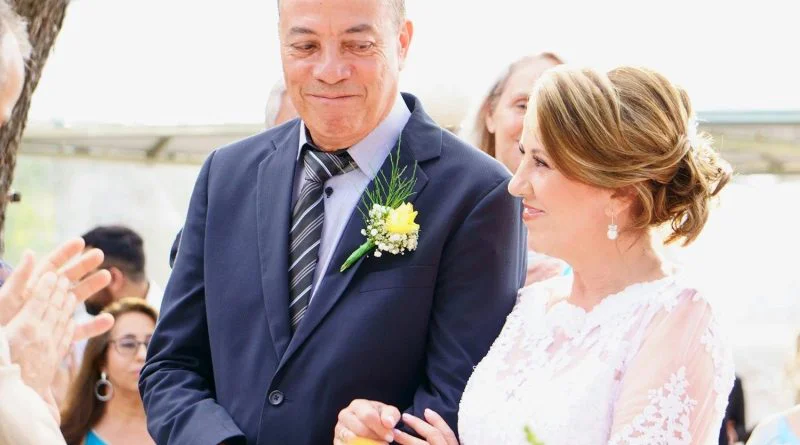A joyful couple shares a special moment during their outdoor wedding ceremony.