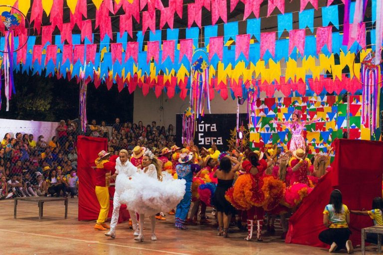 Colorful festival scene with dancers and decorations at a Brazilian celebration.
