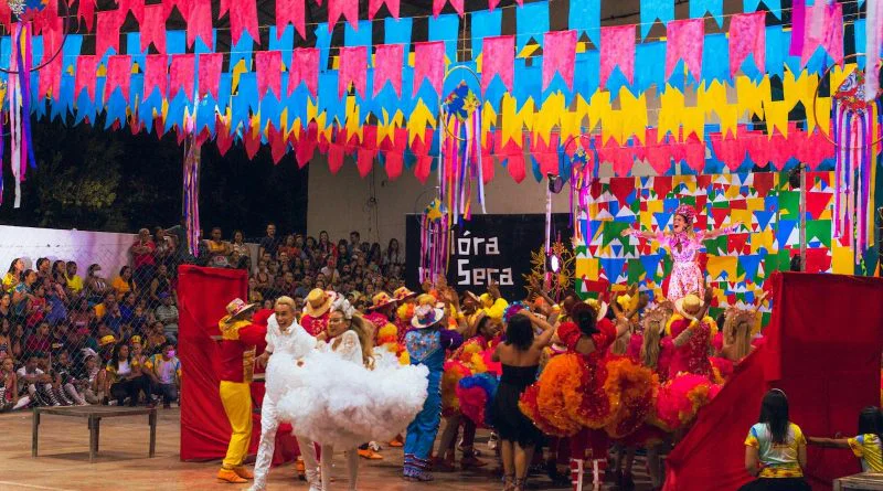 Colorful festival scene with dancers and decorations at a Brazilian celebration.