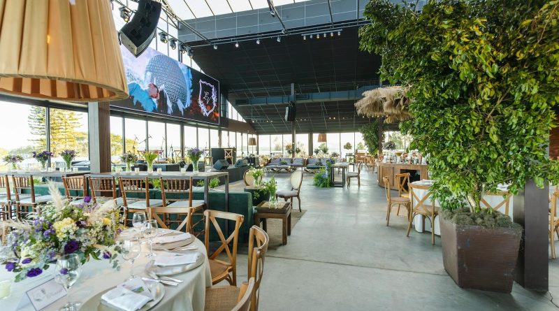 A beautifully decorated indoor reception venue with floral arrangements and elegant table settings.