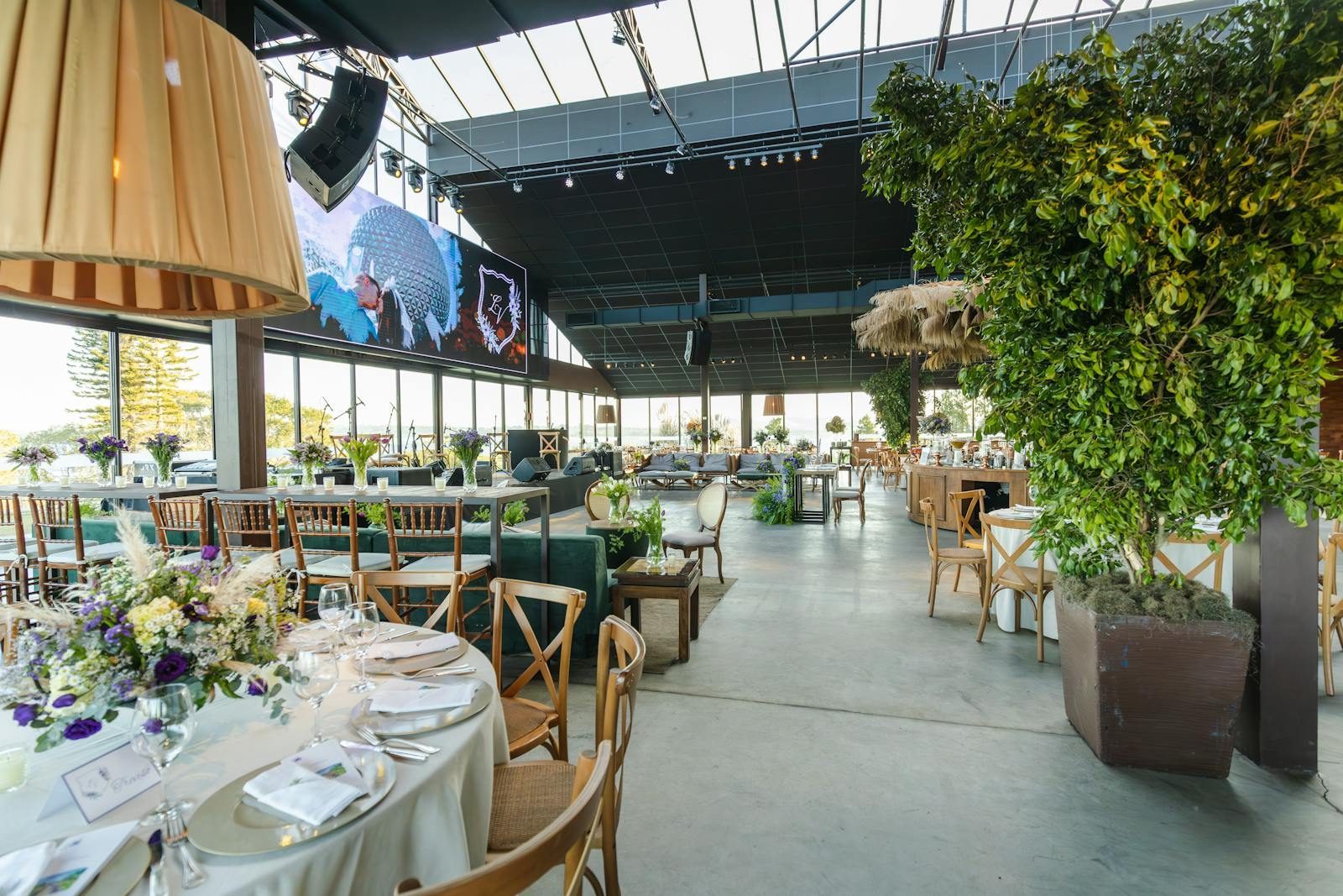 A beautifully decorated indoor reception venue with floral arrangements and elegant table settings.